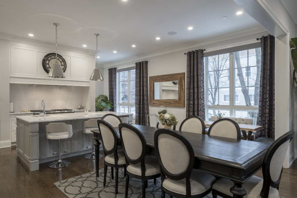 A dining room image with recessed lighting.